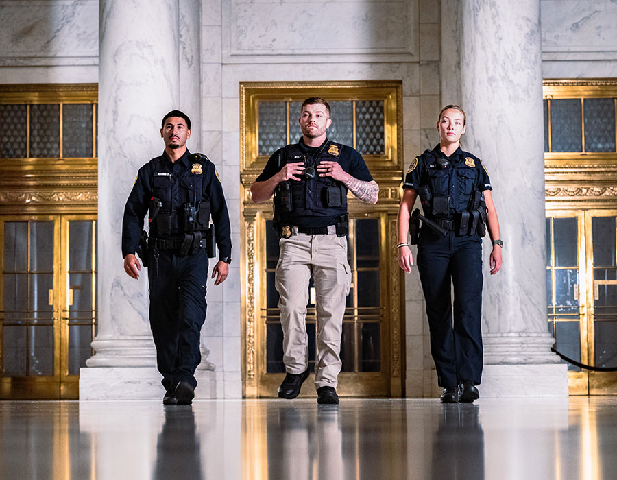 three police officers walking